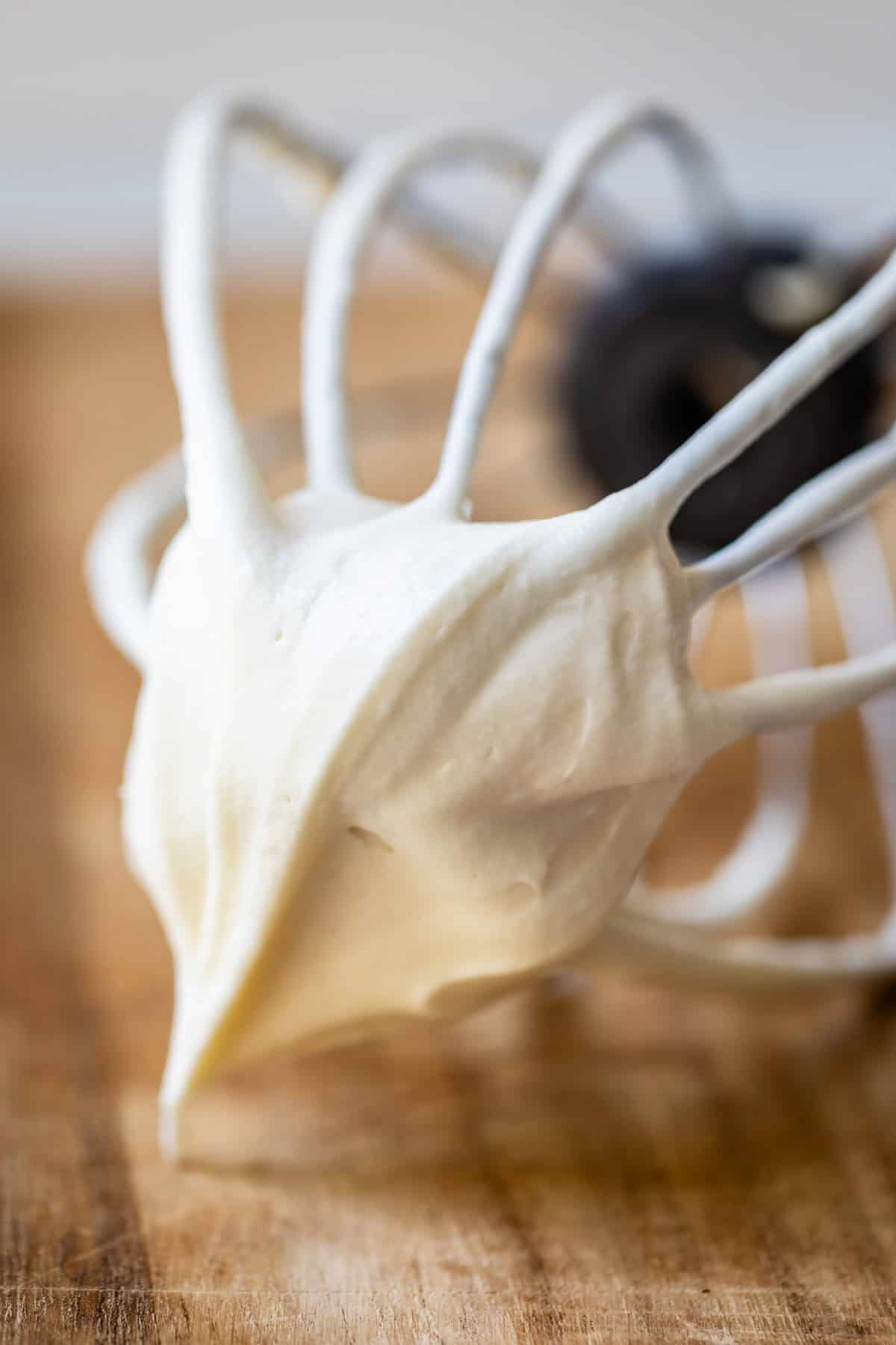 cream cheese frosting with the consistency of whipped cream on a whisk.