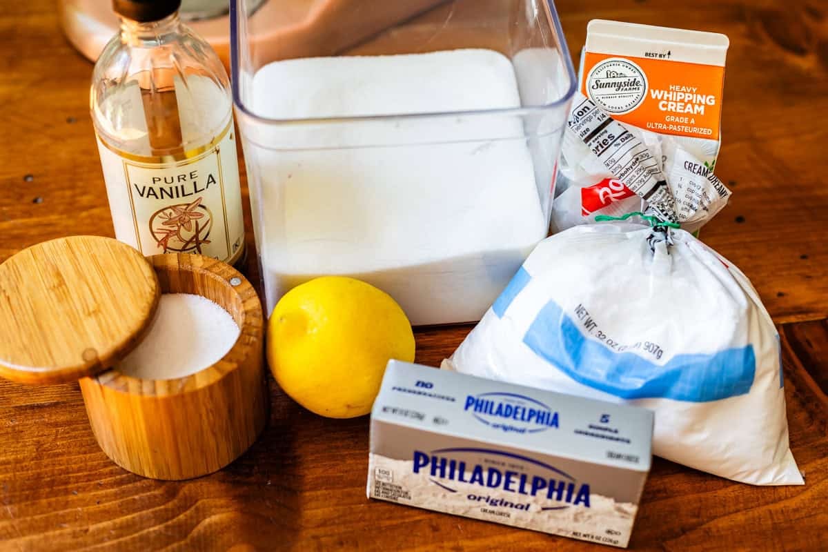 ingredients for whipped cream cream cheese frosting like powdered sugar, lemon, and more.