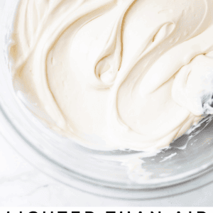 cream cheese frosting swirled in a bowl shot from overhead.