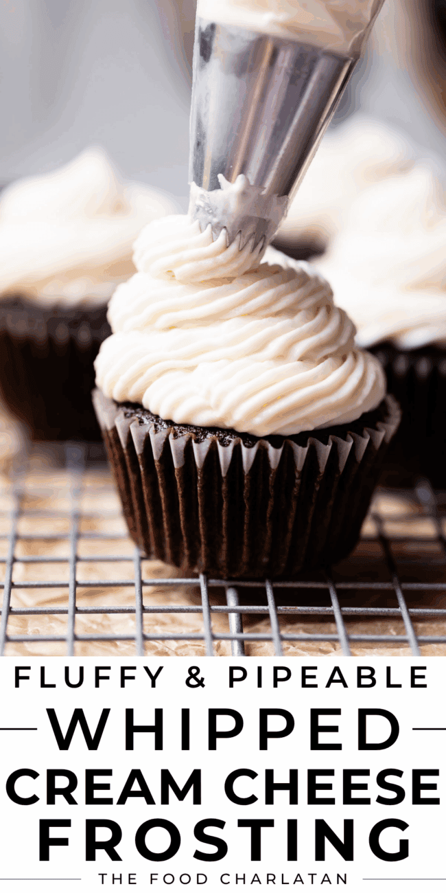 piping whipped cream cheese frosting onto a chocolate cupcake.