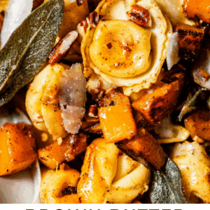 Close-up of tortellini pasta mixed with roasted butternut squash, crispy sage leaves, shaved parmesan, and chopped pecans, topped with a brown butter sauce. Text overlay reads Brown Butter Tortellini with Butternut Squash.