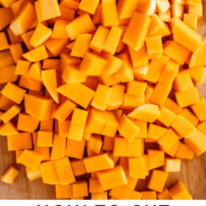 Diced pieces of bright orange butternut squash on a wooden surface with text below reading “How to Cut Butternut Squash: A Step-by-Step Guide – The Food Charlatan.”.