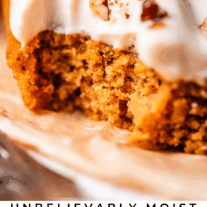 A close-up of a slice of pumpkin sheet cake topped with creamy frosting and chopped pecans, with text below reading Unbelievably Moist Pumpkin Sheet Cake - The Food Charlatan.