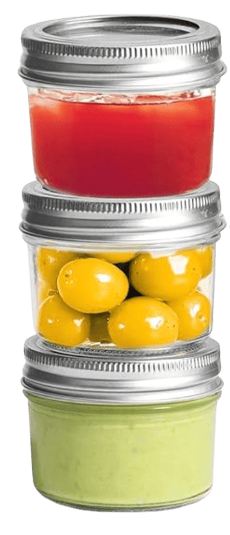 Three small glass jars are stacked vertically. The top jar contains a red liquid, the middle jar holds yellow cherry tomatoes, and the bottom jar is filled with a green creamy substance. All jars have metal lids.