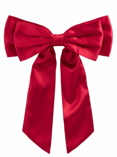 A large, shiny red satin bow with two long, trailing ribbons against a plain, light background.