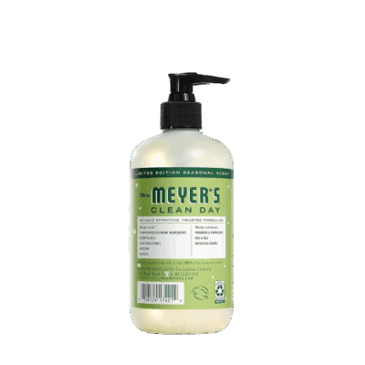 A bottle of Mrs. Meyer’s Clean Day liquid hand soap with a black pump dispenser, featuring a green and white label detailing the product information and scent. The background is plain and light gray.