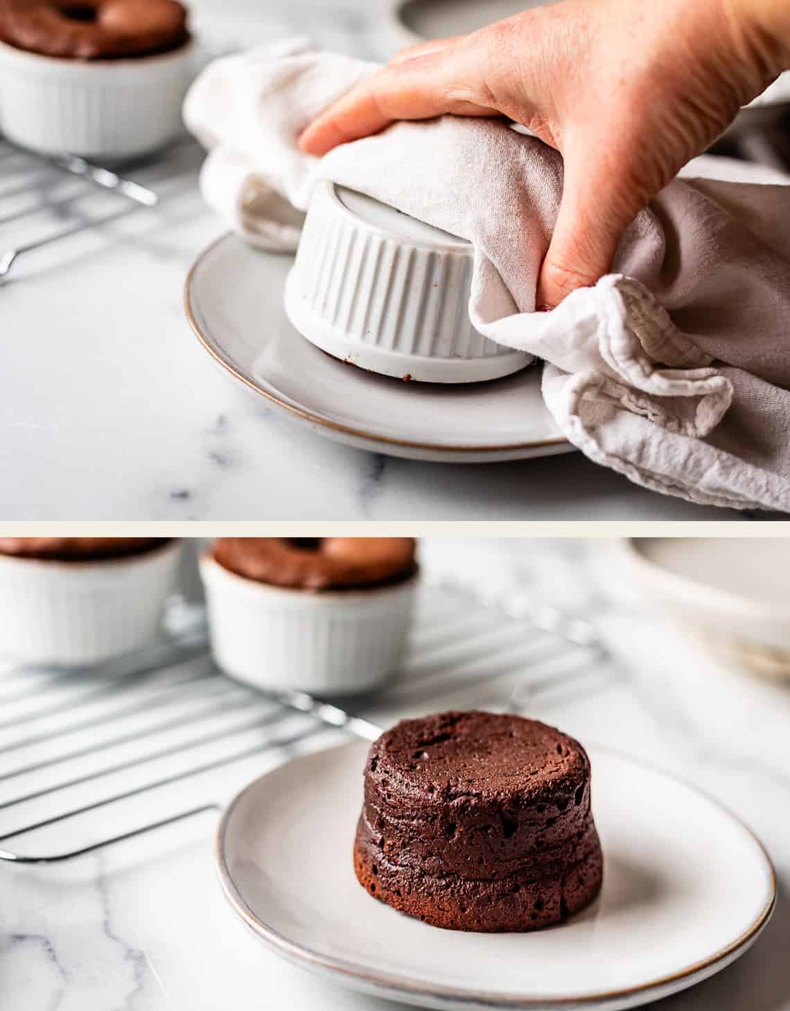 A hand using a cloth to invert a white ramekin onto a plate, then removing the ramekin to reveal a chocolate lava cake. Other ramekins with cakes are on a cooling rack in the background.