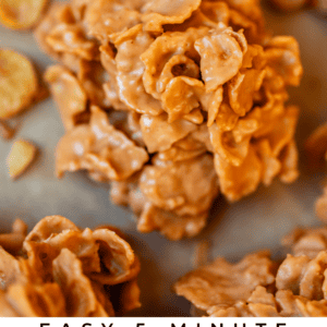 Close-up of golden, crunchy butterscotch cornflake cookies stacked on a tray, with a few scattered cornflakes and butterscotch chips in the background. Text overlay reads: “Easy 5-Minute Butterscotch Cornflake Cookies.”.