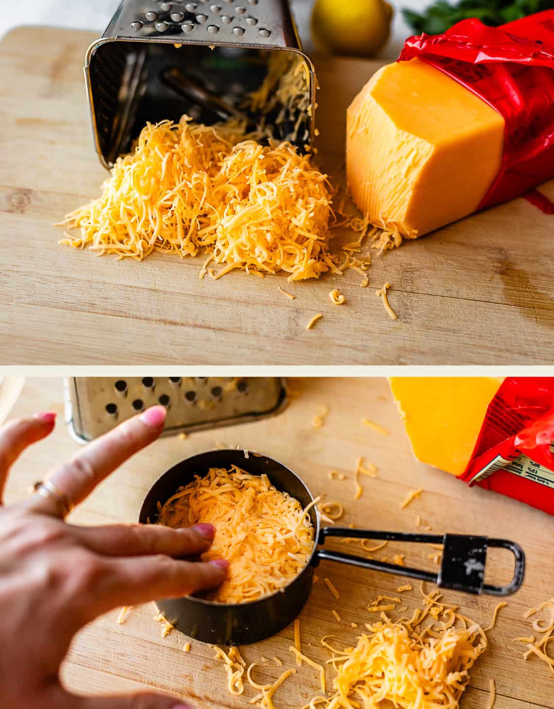 Finely shredded cheddar cheese on a cutting board near a cheese grater and a block of cheddar; a hand fills a measuring cup with the shredded cheese.