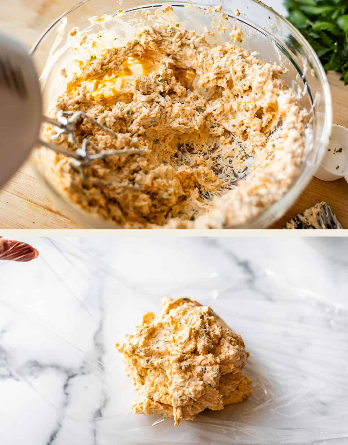 A glass bowl with creamy, herb-filled cheese ball mixture being combined with a hand mixer, and below, the mixture placed on plastic wrap, ready to be rolled on a marble counter.