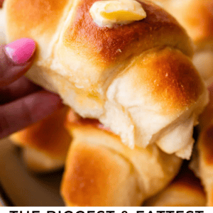 A hand holds a golden, fluffy crescent roll topped with a pat of melting butter. Other crescent rolls are stacked in the background. Text below reads: The biggest & fattest crescent rolls of your life. The Food Charlatan.