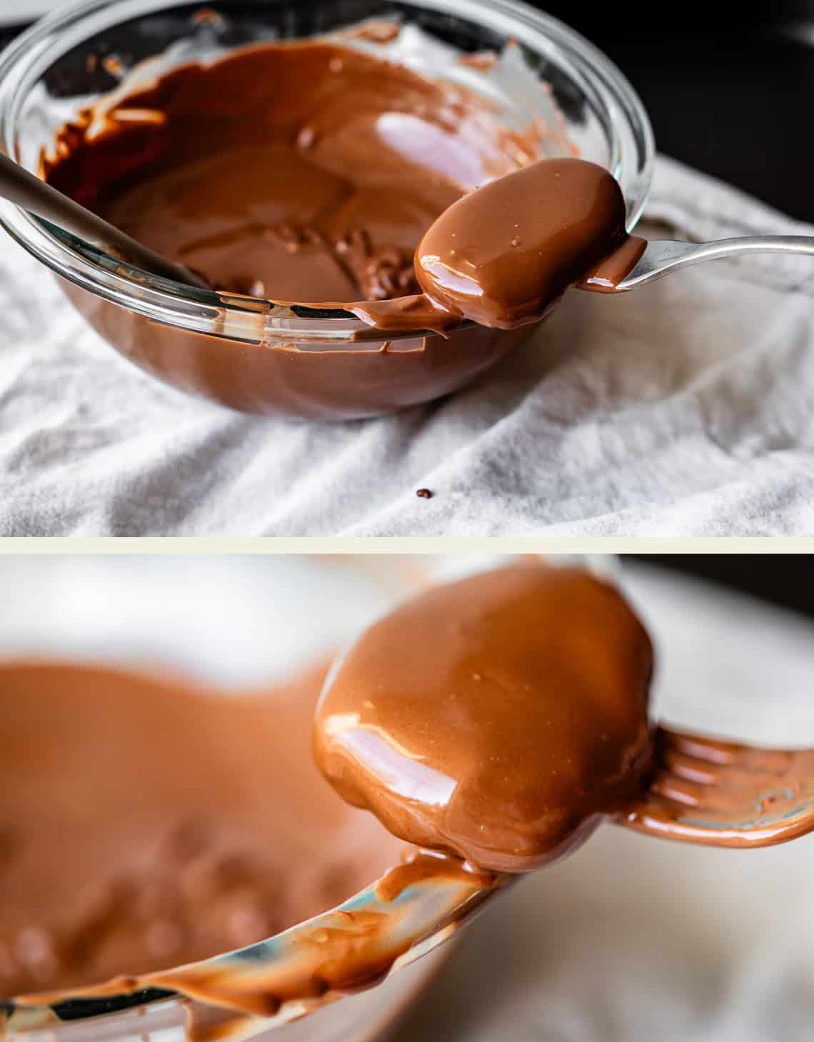 A metal fork holds a smooth, chocolate-covered treat above a glass bowl filled with melted chocolate. The bowl rests on a white cloth, and the treat is coated evenly.