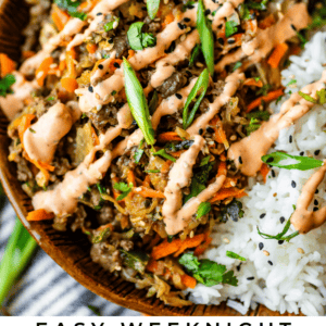 A brown bowl filled with an egg roll mixture of shredded vegetables, ground meat, and sliced green onions, served next to white rice and drizzled with creamy orange sauce. Text reads: Easy Weeknight Egg Roll in a Bowl.