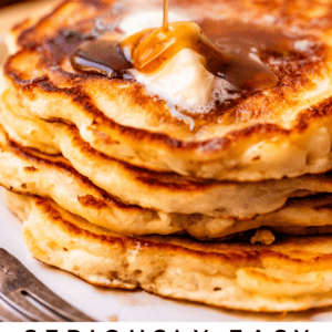 A close-up of a stack of golden pancakes topped with butter, being drizzled with syrup. The text at the bottom reads: Seriously Easy Good Old-Fashioned Pancakes. The Food Charlatan.