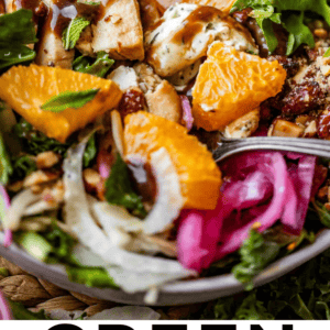 Close-up of a vibrant green salad with citrus orange slices, goat cheese crumbles, pickled onions, fresh herbs, and grilled chicken pieces in a bowl. Text below reads “Green Salad with Citrus & Goat Cheese.”.