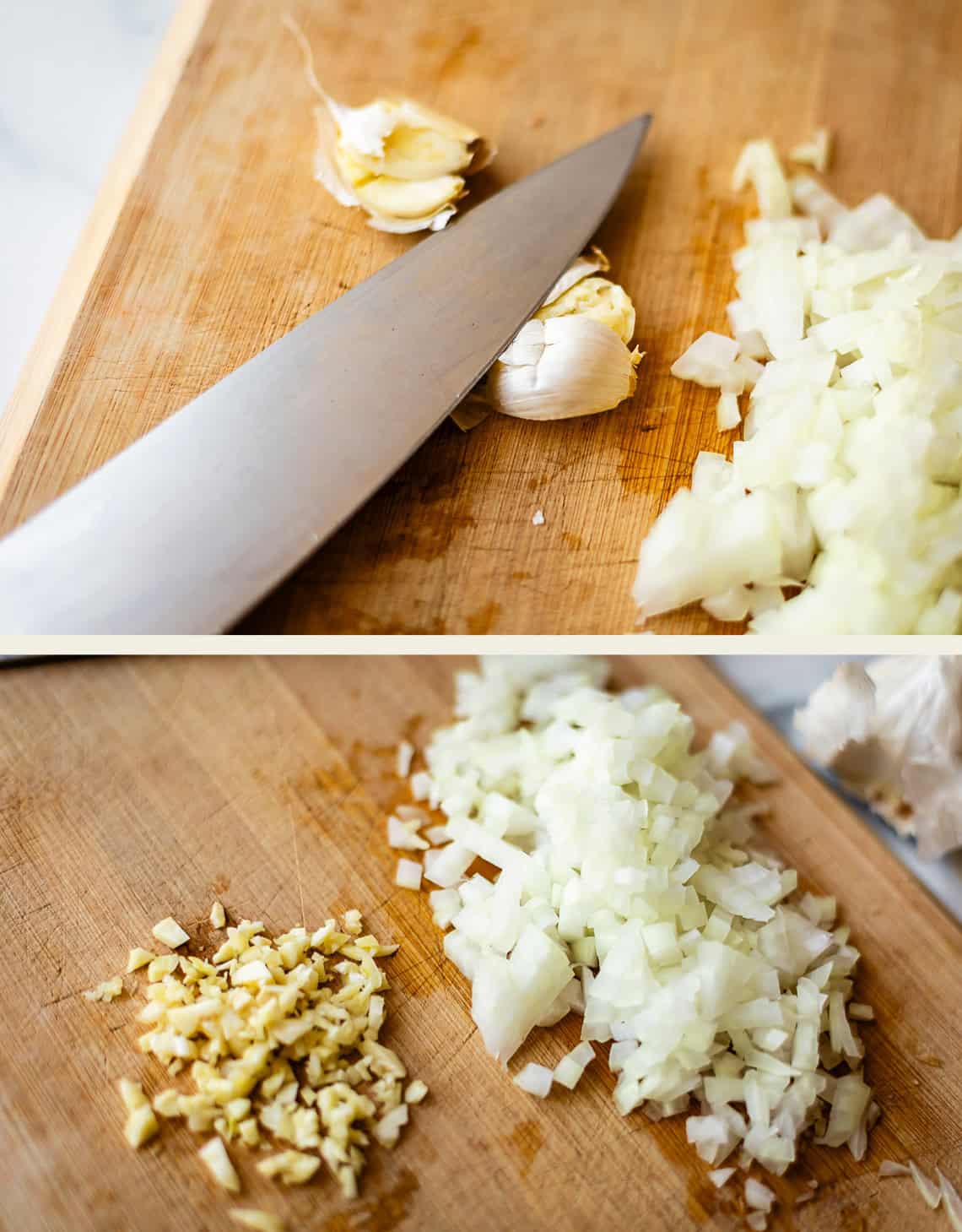 Close-up of a cutting board with chopped onions, minced garlic, and a chefs knife. Garlic cloves and diced onions are separated on the board in two different stages of preparation.