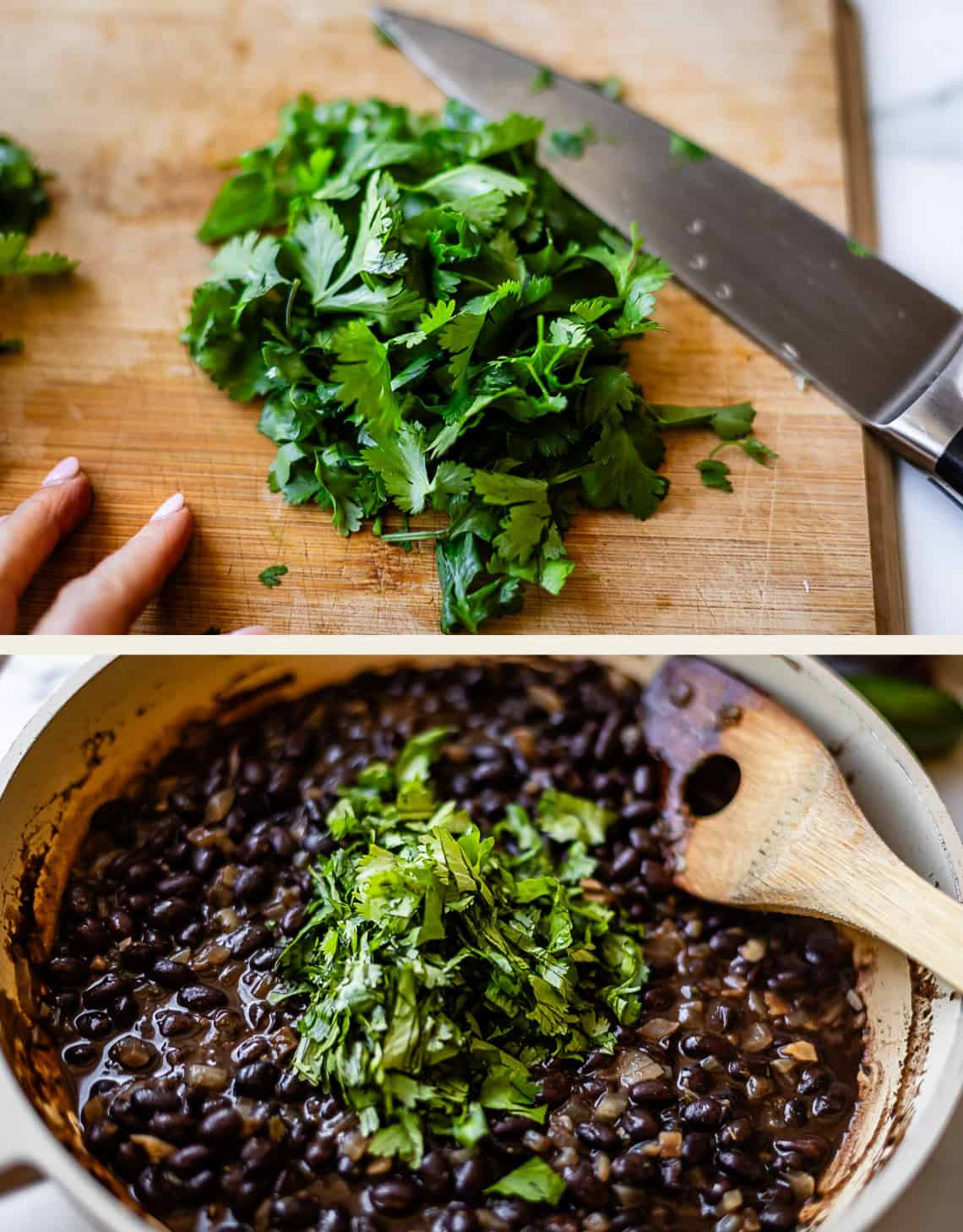 Chopped cilantro on a cutting board with a knife above a pot of cooked black beans topped with fresh cilantro and a wooden spoon.
