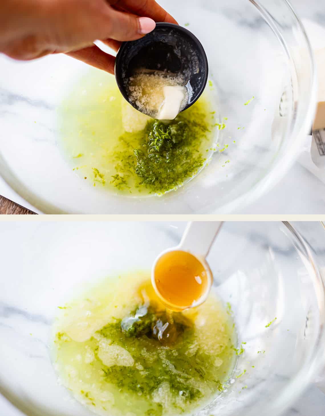 A hand adds a small bowl of white and green ingredients to a large glass bowl, then a tablespoon of honey is poured in. The mixture also includes grated lime zest and liquid.