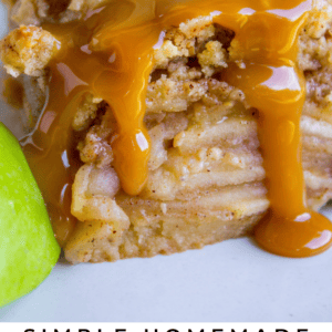 A close-up of an apple pie bar topped with crumbly streusel and dripping caramel sauce, with green apple slices on the side. Text reads: Simple Homemade Apple Pie Bars. The Food Charlatan.