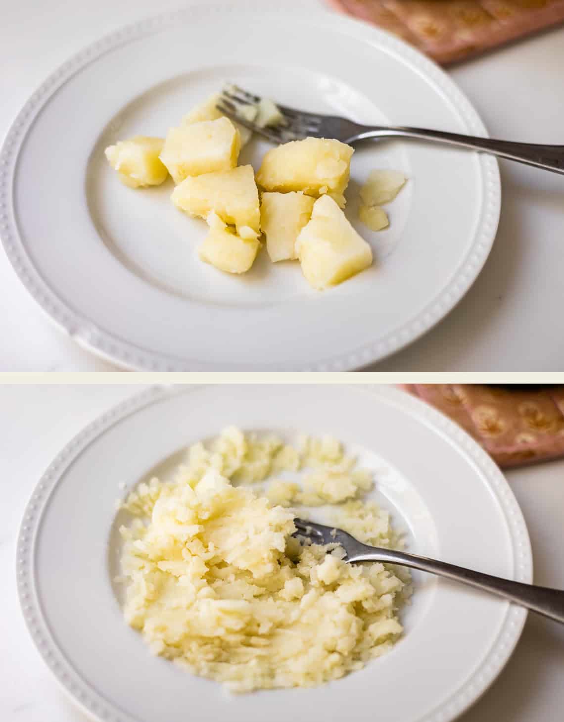 Two white plates: the top plate has several chunks of boiled potato with a fork, while the bottom plate shows the potatoes mashed with the same fork, both resting on a white surface.