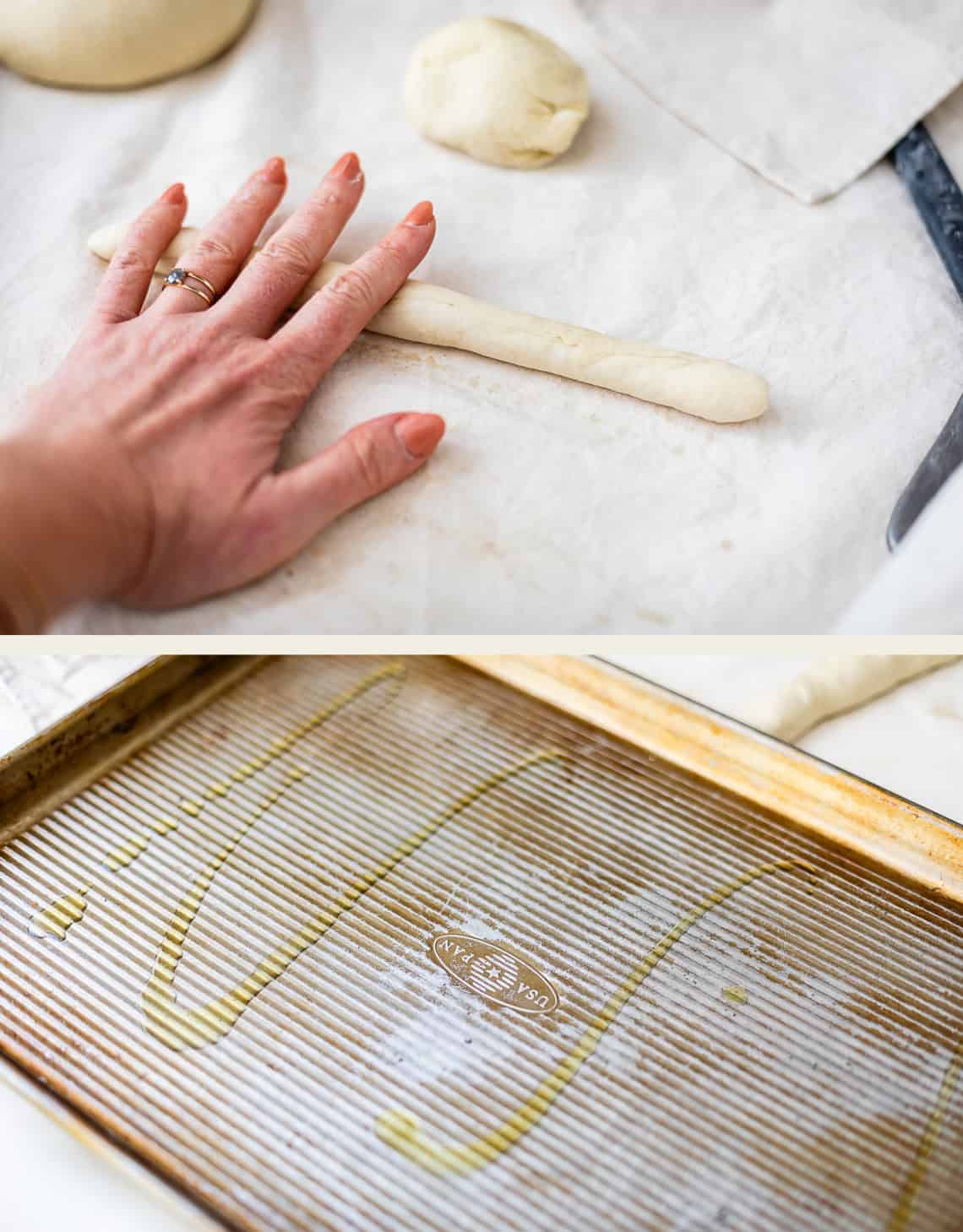A hand rolls a piece of dough into a long shape on a cloth surface, and a baking sheet drizzled with oil.