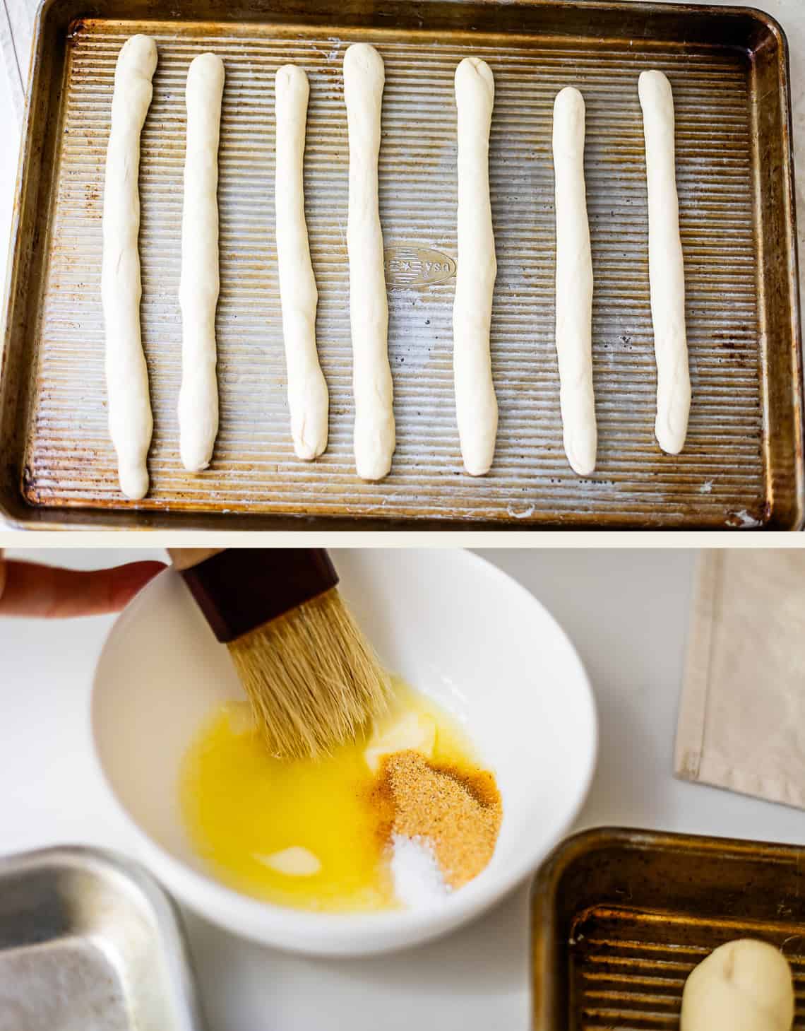 Top: seven lengths of bread dough arranged on a baking sheet. Bottom: a pastry brush mixing melted butter, seasonings, and salt in a white bowl.