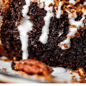 A slice of chocolate cake topped with pecans, chocolate chips, and white glaze, with the text Rich & Fudgy Earthquake Cake below.
